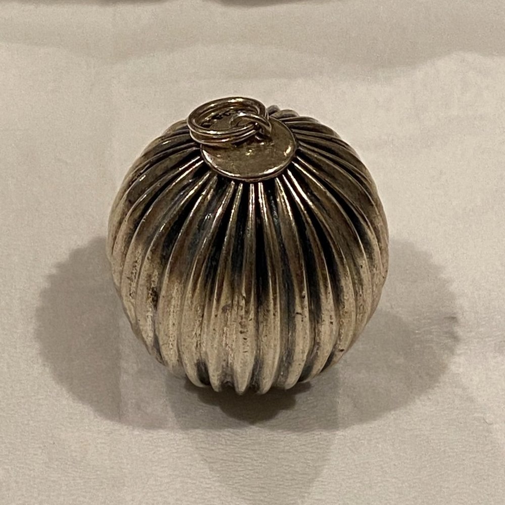 Sterling silver globe pendant.